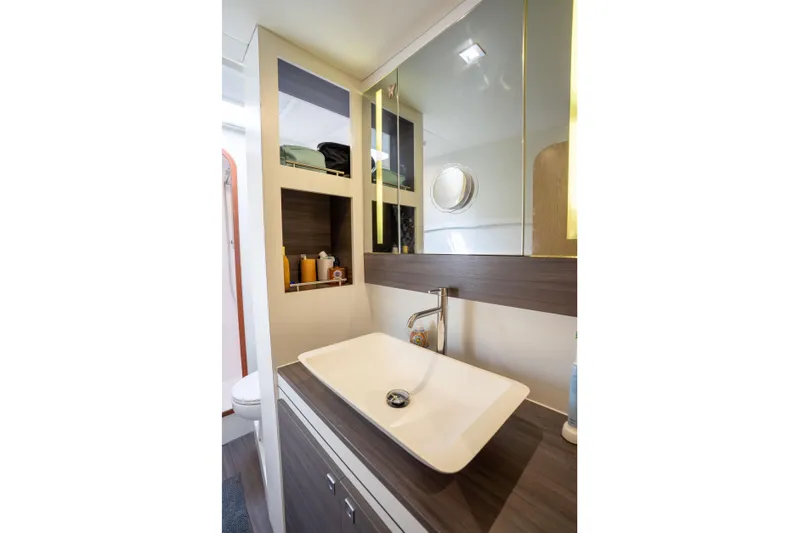 Inky Blue Yacht Photos Pics Modern bathroom interior of 2020 Outremer 51 yacht with sleek sink and storage.