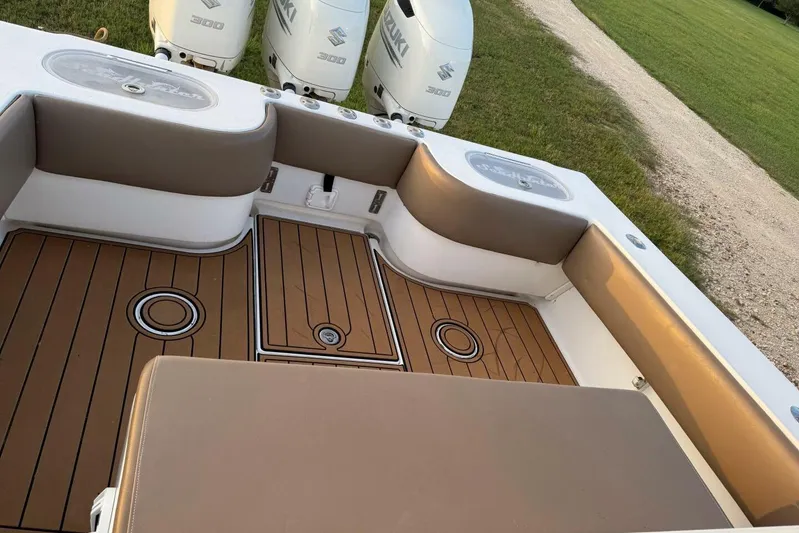 Pass It On Yacht Photos Pics 2014 SeaHunter 40 Tournament boat interior with cushioned seating and Suzuki engines.