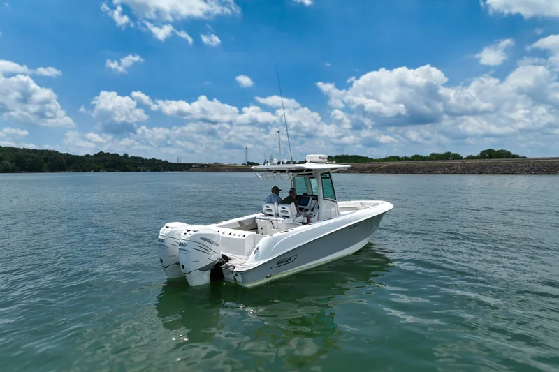  Yacht Photos Pics 2016 Boston Whaler 280 Outrage boat on calm water under a blue sky.