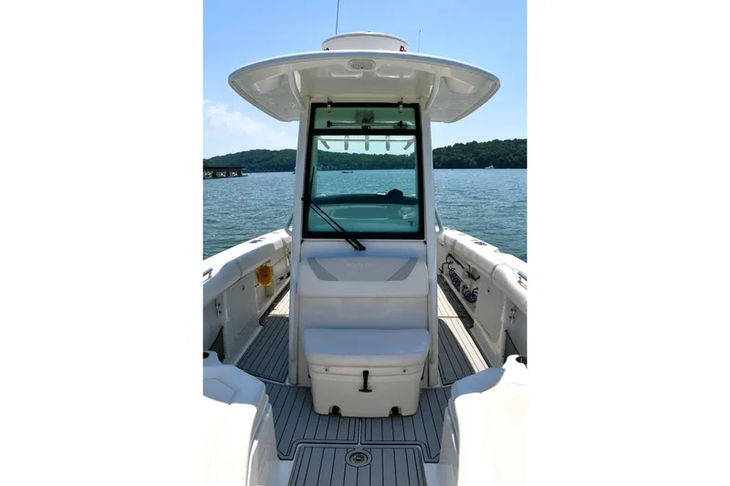  Yacht Photos Pics 2016 Boston Whaler 280 Outrage boat interior with helm, on a sunny day.