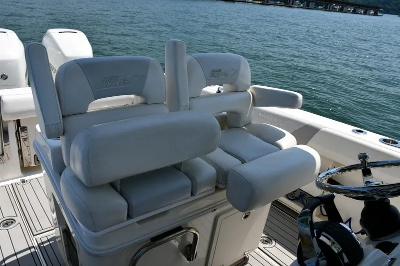  Yacht Photos Pics 2016 Boston Whaler 280 Outrage boat interior with plush seating and steering wheel.