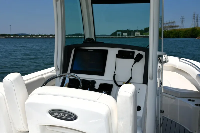  Yacht Photos Pics 2016 Boston Whaler 280 Outrage boat dashboard with steering wheel and navigation system.