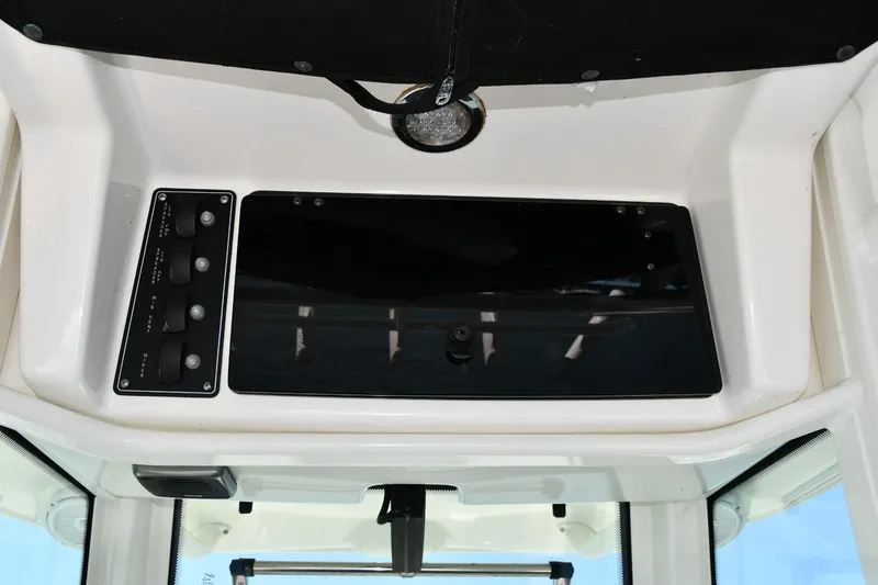  Yacht Photos Pics 2016 Boston Whaler 280 Outrage dashboard with control panel and storage compartment.