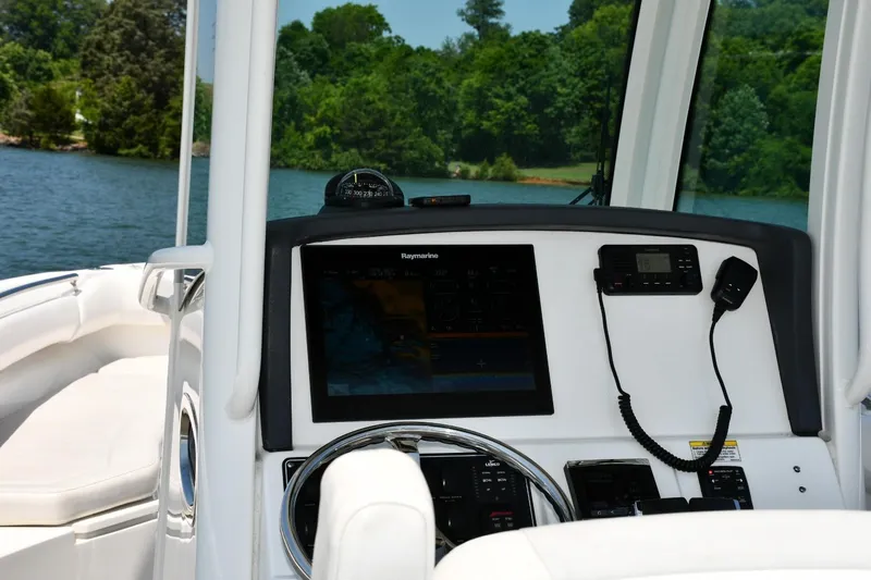  Yacht Photos Pics Boston Whaler 280 Outrage 2016 helm with navigation equipment on a scenic lake.