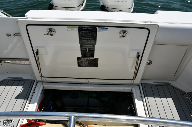  Yacht Photos Pics 2016 Boston Whaler 280 Outrage boat with open hatch and visible engine compartment.