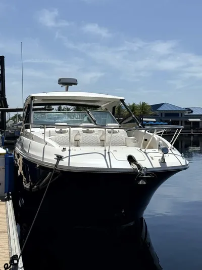 Salty Xperience Yacht Photos Pics 2020 Sea Ray 320 Sundancer OB Coupe docked at marina under clear sky.