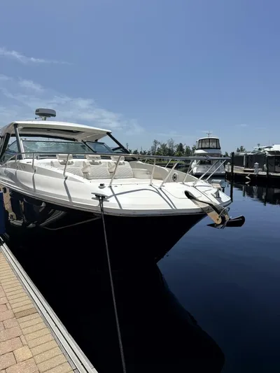 Salty Xperience Yacht Photos Pics 2020 Sea Ray 320 Sundancer OB Coupe docked at marina under clear sky.
