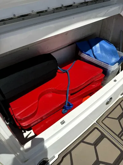 Salty Xperience Yacht Photos Pics Storage compartment on a 2020 Sea Ray 320 Sundancer OB Coupe with red and blue gear.