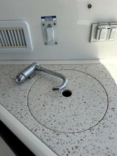 Salty Xperience Yacht Photos Pics 2020 Sea Ray 320 Sundancer OB Coupe sink with chrome faucet and speckled countertop.