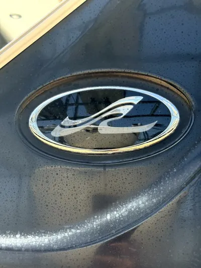Salty Xperience Yacht Photos Pics Close-up of Sea Ray 320 Sundancer OB Coupe 2020 logo on a wet surface.