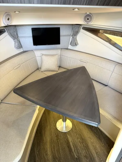 Salty Xperience Yacht Photos Pics Interior of 2020 Sea Ray 320 Sundancer OB Coupe with triangular table and seating.