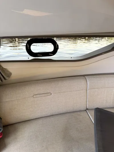 Salty Xperience Yacht Photos Pics Interior view of 2020 Sea Ray 320 Sundancer OB Coupe with water visible through window.