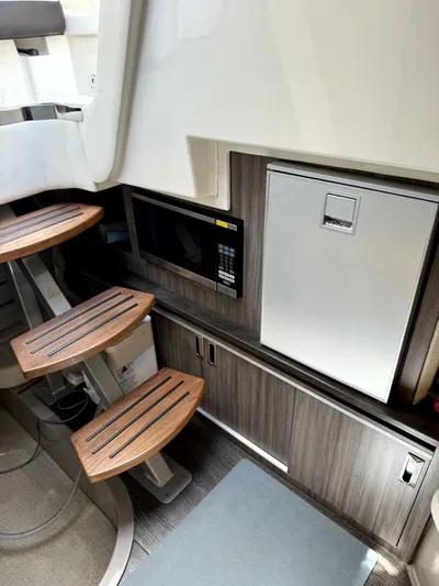 Salty Xperience Yacht Photos Pics Interior of 2020 Sea Ray 320 Sundancer OB Coupe with stairs, microwave, and fridge.