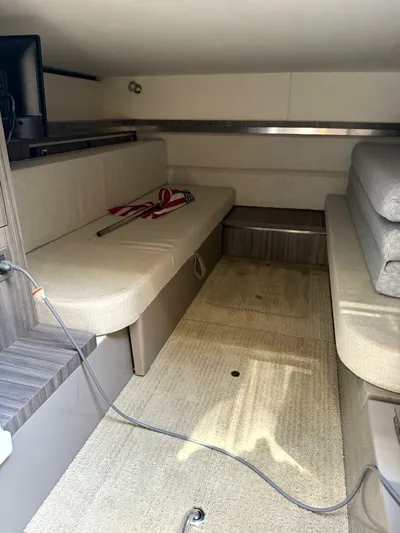 Salty Xperience Yacht Photos Pics Interior cabin of 2020 Sea Ray 320 Sundancer OB Coupe, featuring beige seating and carpet.