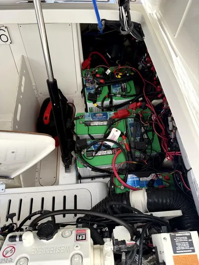 Salty Xperience Yacht Photos Pics Engine compartment of 2020 Sea Ray 320 Sundancer OB Coupe with visible batteries and wiring.