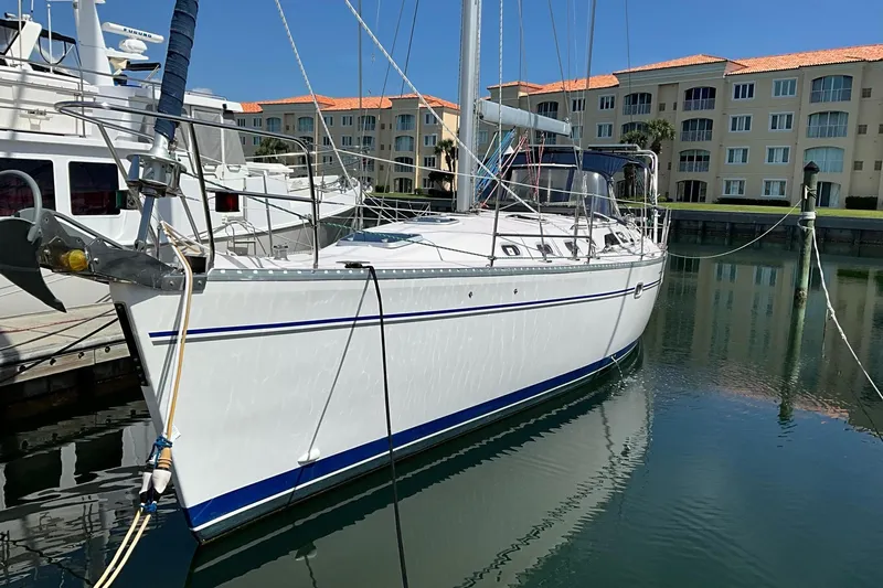 Spellbound Yacht Photos Pics Sailboat Catalina 470, 2000 model, docked in a marina with waterfront buildings.