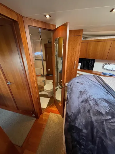 Navygator Yacht Photos Pics Luxurious 2009 Regal 5260 Sport Coupe yacht interior with wooden cabinetry and modern bathroom.