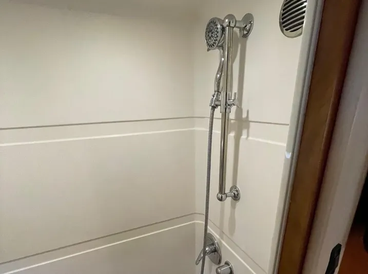 Navygator Yacht Photos Pics Shower area in 2009 Regal 5260 Sport Coupe yacht, featuring chrome fixtures and white walls.