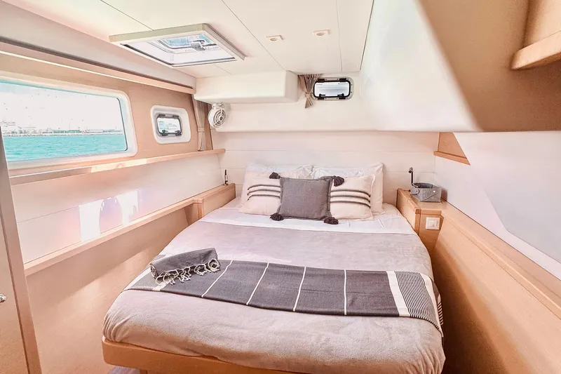  Yacht Photos Pics Luxurious cabin interior of 2016 Lagoon 450 F catamaran with cozy bed and ocean view.