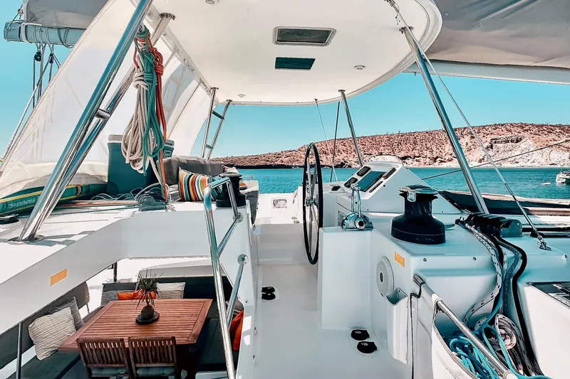  Yacht Photos Pics 2016 Lagoon 450 F catamaran interior with steering wheel, seating, and ocean view.