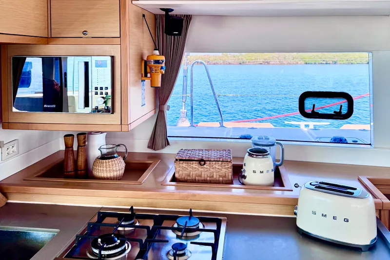  Yacht Photos Pics Kitchen interior of 2016 Lagoon 450 F yacht with ocean view through window.