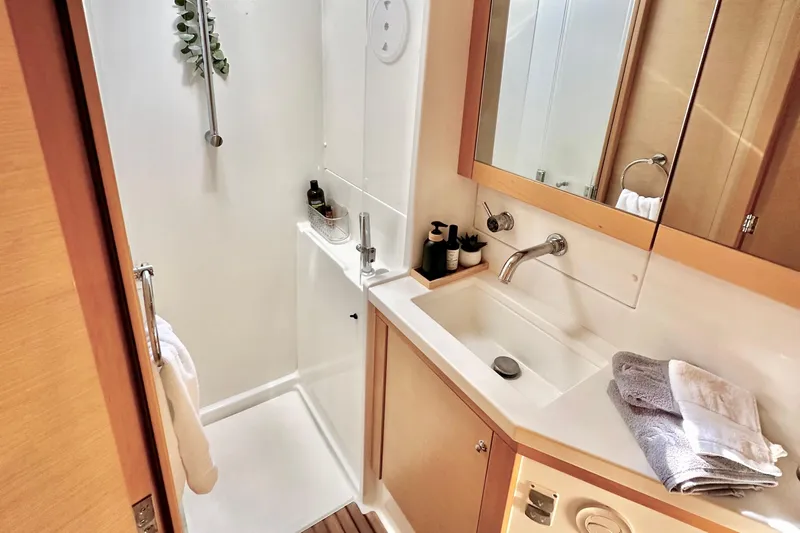  Yacht Photos Pics Luxurious bathroom in 2016 Lagoon 450 F yacht with modern fixtures and elegant design.