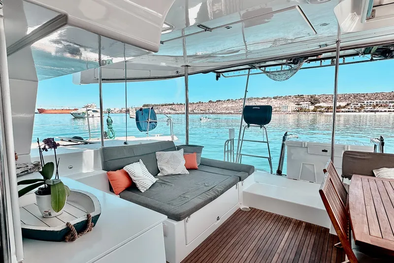  Yacht Photos Pics Luxurious Lagoon 450 F catamaran interior with comfortable seating, overlooking serene waters.