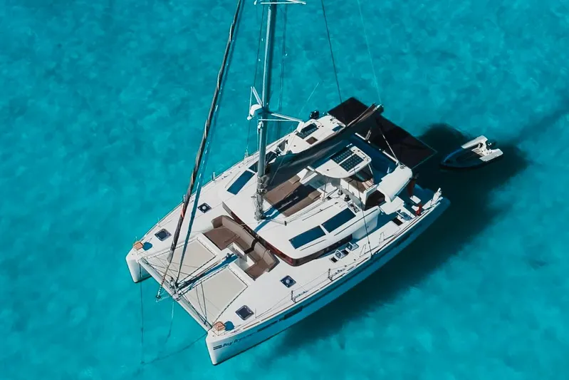  Yacht Photos Pics 2016 Lagoon 450 F catamaran sailing on clear turquoise waters.