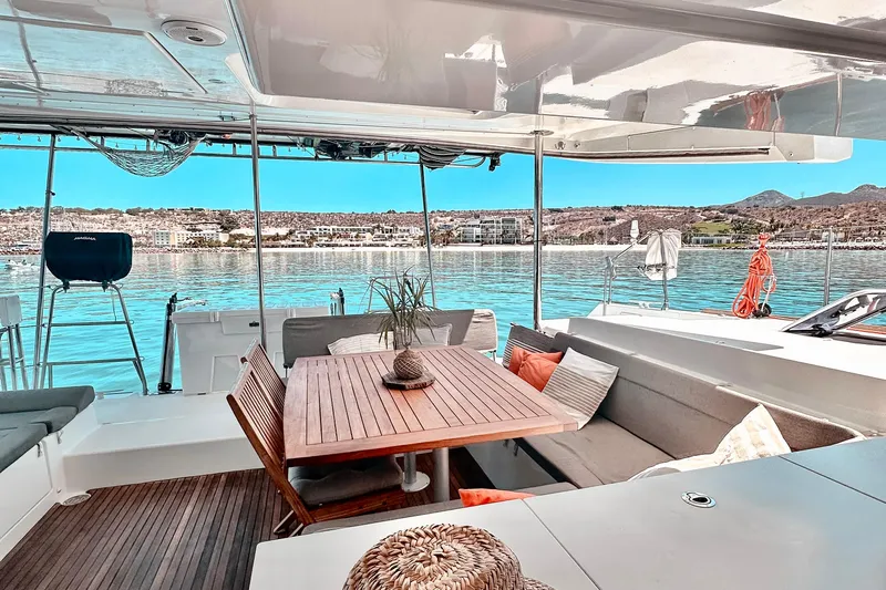 Yacht Photos Pics Luxurious Lagoon 450 F catamaran interior with elegant seating and scenic waterfront view.