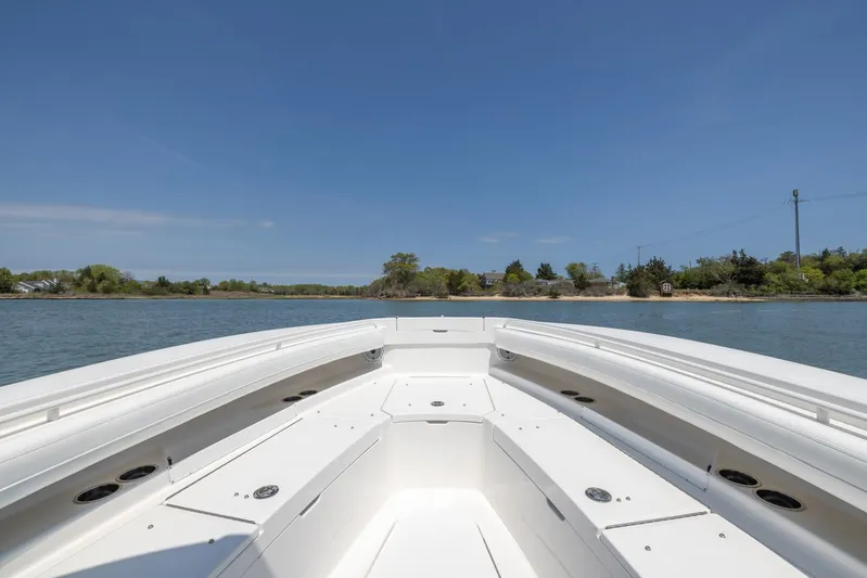 Big D Yacht Photos Pics 2021 Regulator 28FS boat on calm water under clear blue sky.