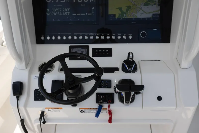 Big D Yacht Photos Pics 2021 Regulator 28FS boat dashboard with steering wheel and navigation controls.