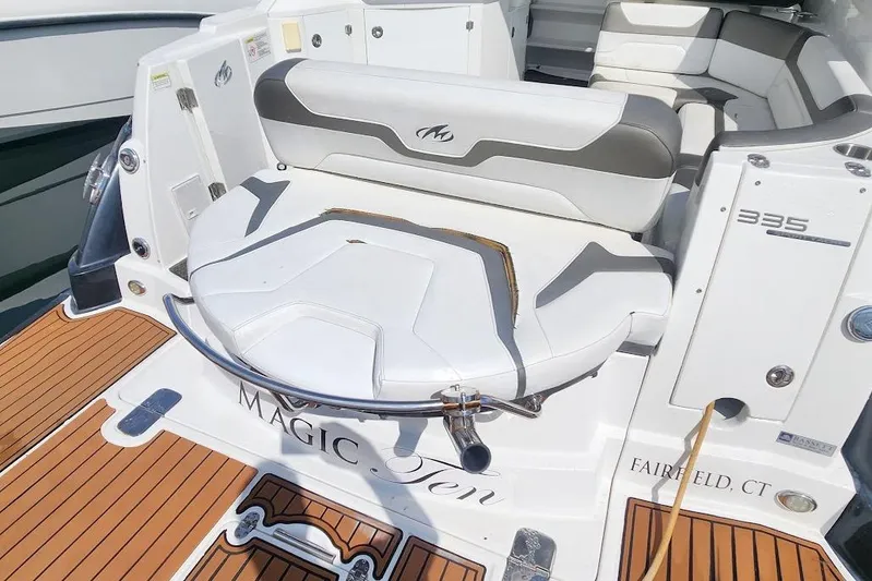 "magic Ten" Yacht Photos Pics 2015 Monterey 335 Sport Yacht, rear seating area with elegant white and gray upholstery.