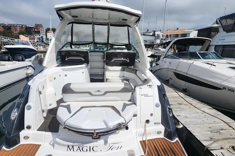 "magic Ten" Yacht Photos Pics 2015 Monterey 335 Sport Yacht docked, showcasing spacious seating and sleek design.