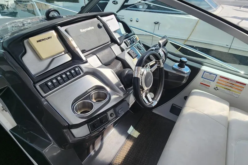 "magic Ten" Yacht Photos Pics 2015 Monterey 335 Sport Yacht helm with steering wheel and navigation controls.