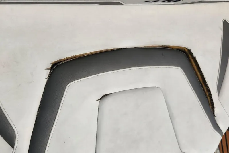 "magic Ten" Yacht Photos Pics Damaged upholstery on 2015 Monterey 335 Sport Yacht seat, showing wear and tear.