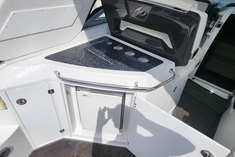 "magic Ten" Yacht Photos Pics 2015 Monterey 335 Sport Yacht kitchenette with countertop, storage, and mini fridge.