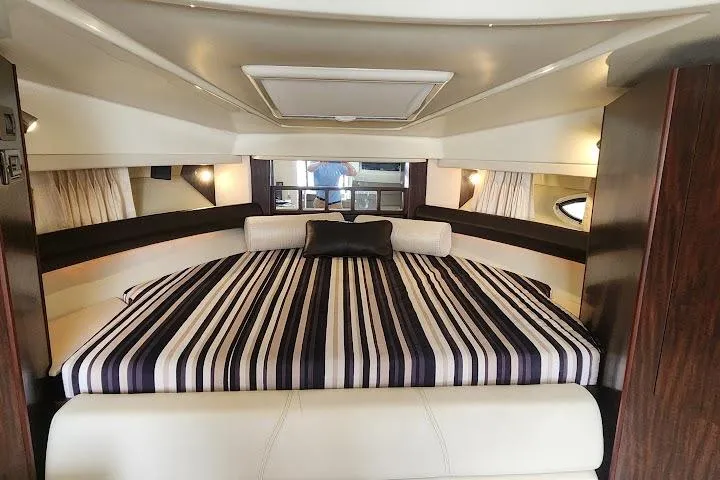 "magic Ten" Yacht Photos Pics Luxurious interior of 2015 Monterey 335 Sport Yacht with striped bedding and elegant design.