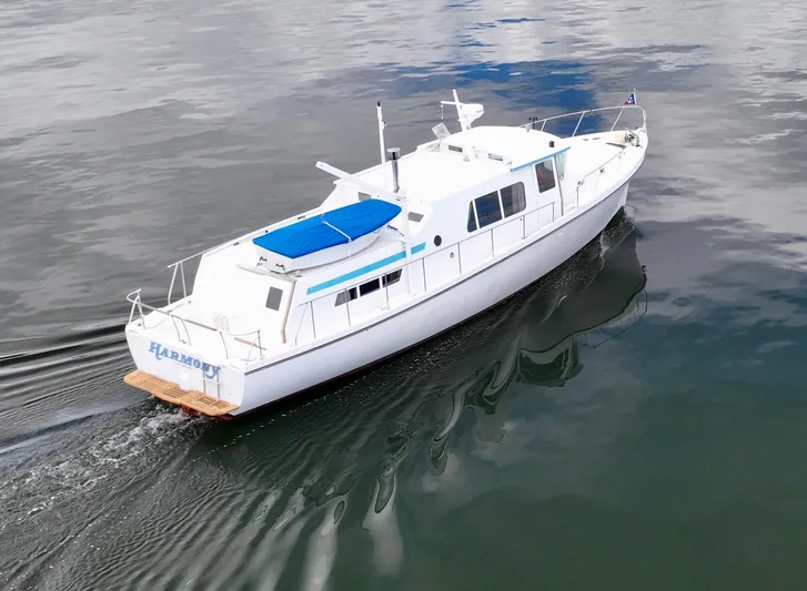 Harmony Yacht Photos Pics 1980 Custom TRI CABIN boat cruising on calm water.