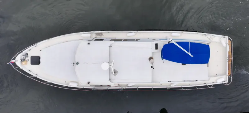 Harmony Yacht Photos Pics Aerial view of a 1980 Custom TRI CABIN boat with a blue cover.