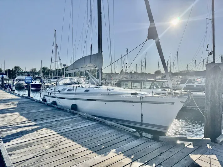  Yacht Photos Pics Sailboat Beneteau 45 First 1991 docked at marina under bright sun.