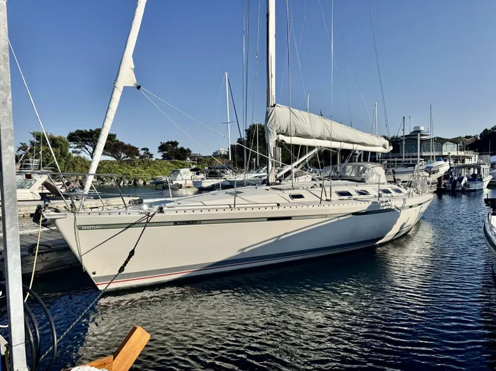  Yacht Photos Pics Sailboat Beneteau 45 First 1991 docked in a marina under clear blue sky.