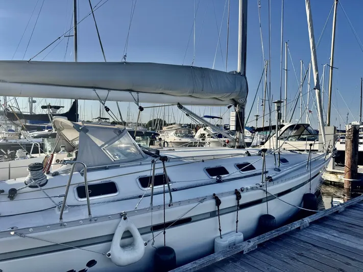  Yacht Photos Pics Sailboat Beneteau 45 First 1991 docked at marina, clear sky background.