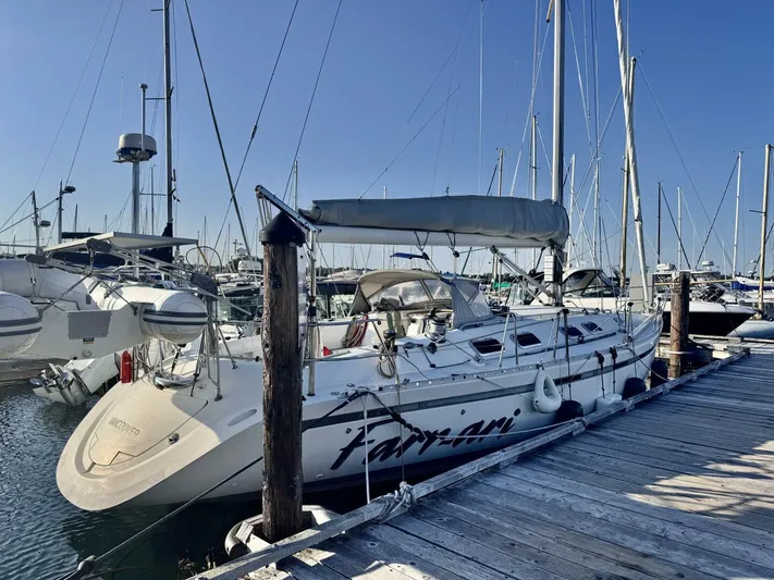  Yacht Photos Pics Sailboat docked at marina, Beneteau 45 First, 1991 model, clear blue sky.
