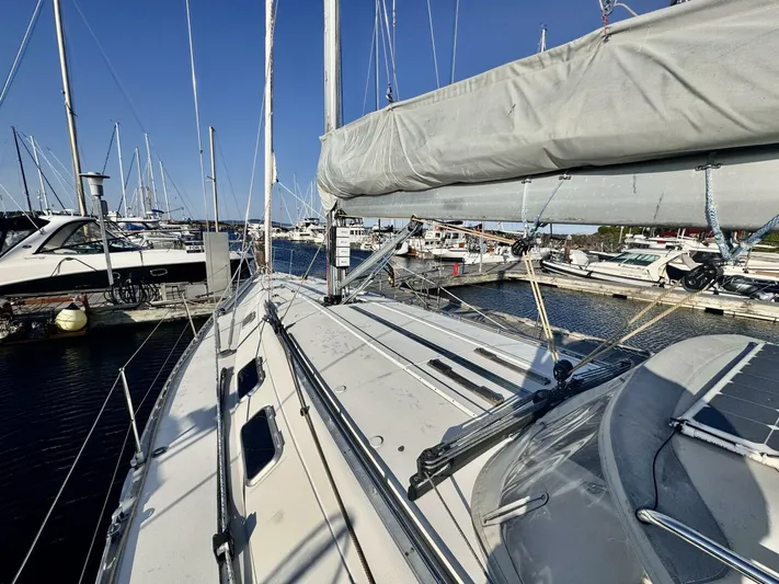  Yacht Photos Pics Sailboat Beneteau 45 First 1991 docked at marina, clear sky, calm waters.