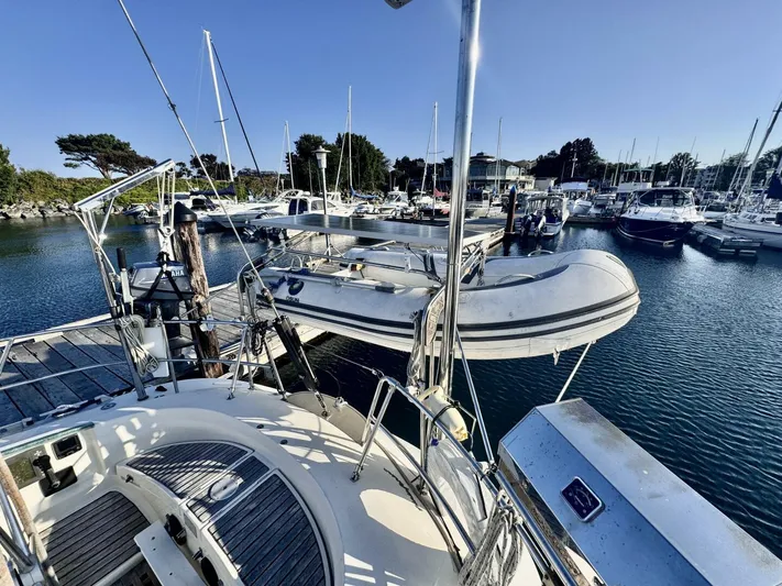  Yacht Photos Pics Sailboat docked at marina, Beneteau 45 First, 1991 model, with inflatable dinghy.