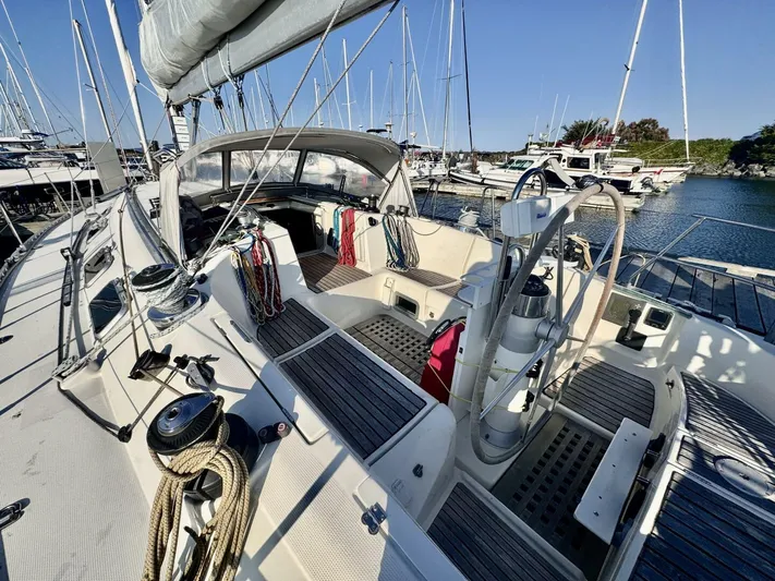  Yacht Photos Pics 1991 Beneteau 45 First sailboat cockpit with ropes and steering wheel in marina.