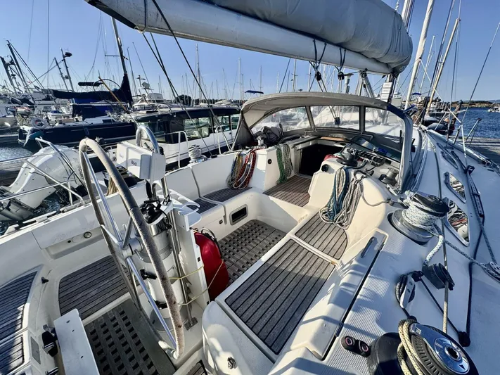  Yacht Photos Pics Cockpit view of 1991 Beneteau 45 First sailboat, docked in a marina.