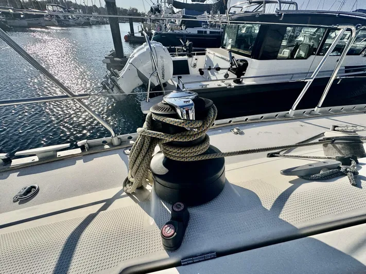  Yacht Photos Pics Deck of 1991 Beneteau 45 First sailboat with winch and rope, docked at marina.