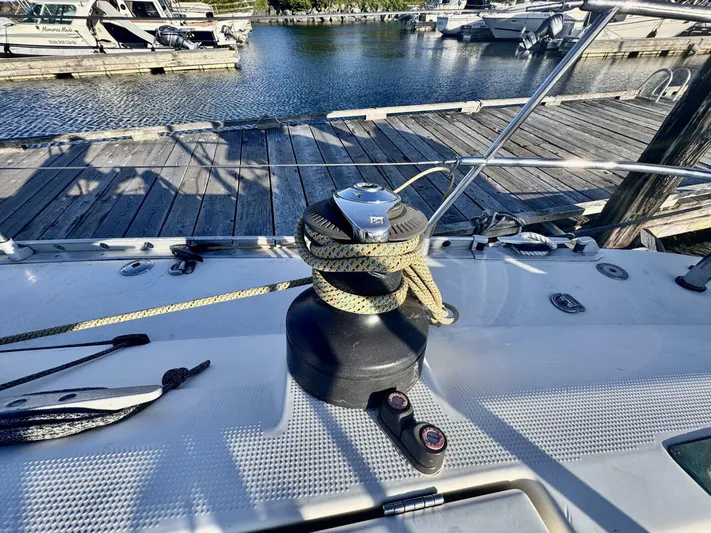  Yacht Photos Pics Deck of 1991 Beneteau 45 First sailboat with winch and rope at marina.