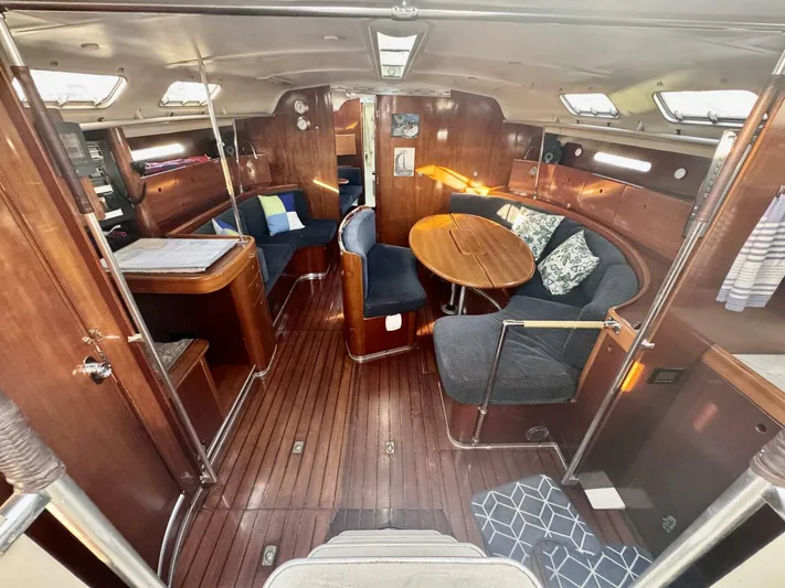  Yacht Photos Pics Luxurious interior of a 1991 Beneteau 45 First yacht with elegant wood finish and cozy seating.